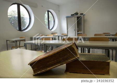 Old books on school desk in classroom 141036352