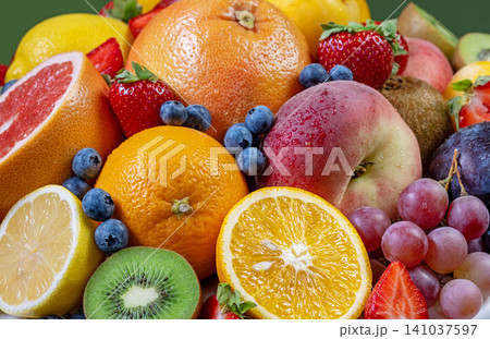 Fresh Assorted Fruits Background with Citrus, Berries and Grapes Fresh Assorted Fruits Background with Citrus, Berries and Grapes 141037597