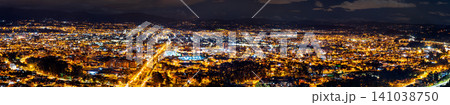A wide panoramic view of the illuminated city of Cuenca in Ecuador at night, seen from the Turi viewpoint. A wide panoramic view of the illuminated city of Cuenca in Ecuador at night, seen from the Turi viewpoint. 141038750
