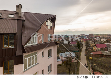 High apartment building with many windows and metal sheets roof. High apartment building with many windows and metal sheets roof. 141038990