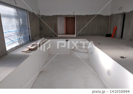 Interior of a house with big swimmig pool under renovation works. Interior of a house with big swimmig pool under renovation works. 141038994