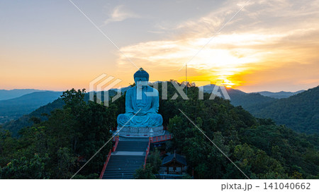 Aerial view of Majestic Buddha on the mountain at colorful sunrise Aerial view of Majestic Buddha on the mountain at colorful sunrise 141040662