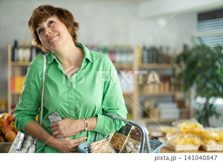Middle-aged woman felt unwell and had abdominal pain while shopping. Buyer Middle-aged woman felt unwell and had abdominal pain while shopping. Buyer 141040847