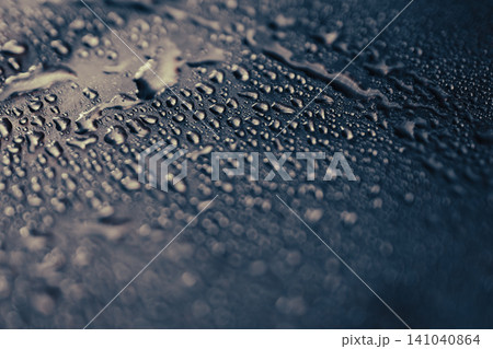 Water droplets on a dark metallic surface reflecting ligh and forming an abstract pattern in monochrome Water droplets on a dark metallic surface reflecting ligh and forming an abstract pattern in monochrome 141040864