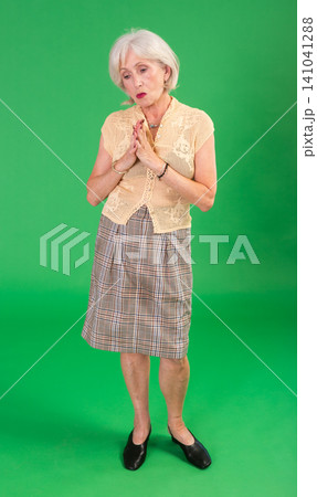 Upset and distressed senior woman person in beige suit, green screen Upset and distressed senior woman person in beige suit, green screen 141041288