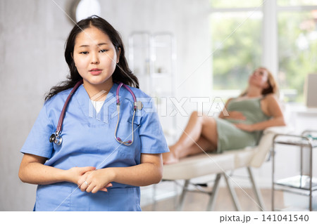 Portrait of female cosmetologist standing in cosmetology clinic 141041540