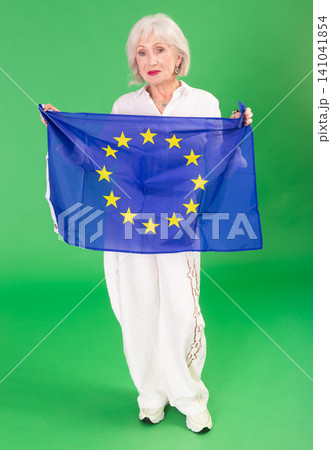 Elderly woman holding EU flag in front of green screen Elderly woman holding EU flag in front of green screen 141041854