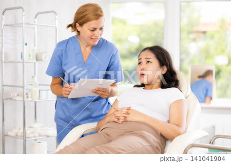 Asian woman signing a facial procedure contract Asian woman signing a facial procedure contract 141041904