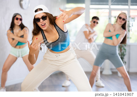 Young girl dancing krump with group in dance studio 141041907
