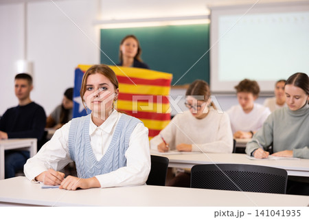 Young girl student diligently studies at school Young girl student diligently studies at school 141041935