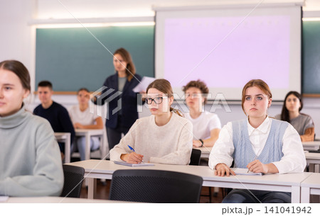 Young girls students study diligently at school Young girls students study diligently at school 141041942