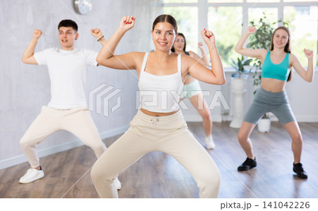 Young girl krumper dancing with group of teenagers in studio Young girl krumper dancing with group of teenagers in studio 141042226