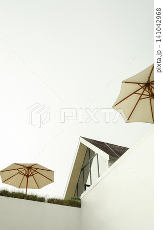 Umbrellas above a building in Bali with clear sky 141042968