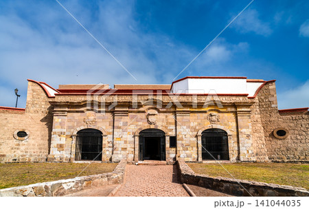A wide angle view of the historic stone facade and entrance of the Real Felipe Fortress under a blue sky in Callao, Peru. A wide angle view of the historic stone facade and entrance of the Real Felipe Fortress under a blue sky in Callao, Peru. 141044035