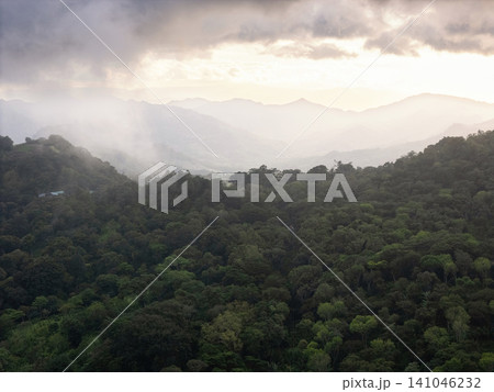 Mountains covered in green forests under cloudy sky during afternoon Mountains covered in green forests under cloudy sky during afternoon 141046232