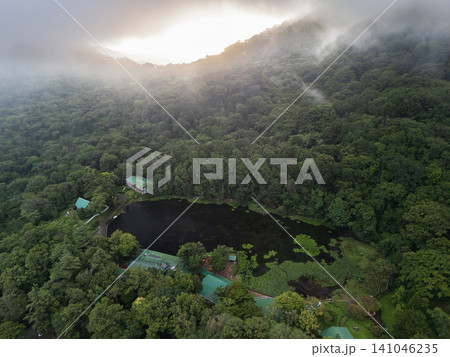 Cloudy morning over a forest lake in the mountains Cloudy morning over a forest lake in the mountains 141046235
