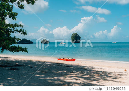 Beautiful Tropical Beach with Clear Blue Water and Limestone Islands in Krabi Beautiful Tropical Beach with Clear Blue Water and Limestone Islands in Krabi 141049933