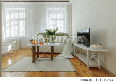 Cozy Living Room Interior with Staged Coffee Table and TV Cozy Living Room Interior with Staged Coffee Table and TV 141050253