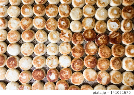 Freshly baked round bread rolls arranged neatly on a tray Freshly baked round bread rolls arranged neatly on a tray 141051670