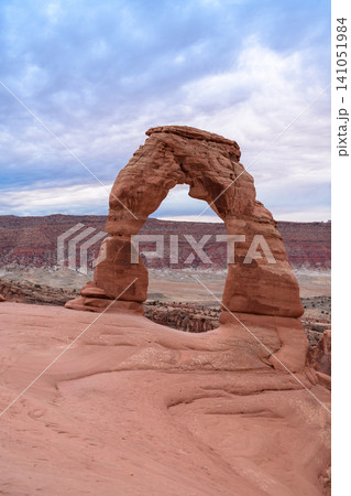 Majestic natural arch, stunning sandstone formation, stands proudly in rugged utah desert landscape under dramatic sky. impressive sight inspires wonder and profound sense of awe Majestic natural arch, stunning sandstone formation, stands proudly in rugged utah desert landscape under dramatic sky. impressive sight inspires wonder and profound sense of awe 141051984