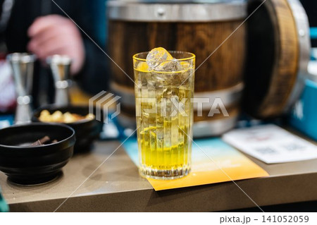 Refreshing cocktail with vibrant colors served at a trendy bar Refreshing cocktail with vibrant colors served at a trendy bar 141052059
