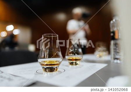 Enjoying fine whiskey at a tasting event in a cozy, intimate venue 141052068
