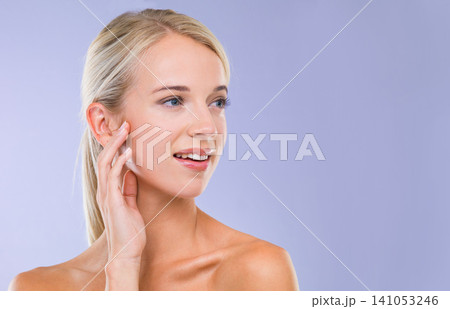 Woman, skincare and wellness in studio with space, results or hand on face with natural glow by purple background. Girl, person and model with cosmetics, mock up and facial transformation for beauty Woman, skincare and wellness in studio with space, results or hand on face with natural glow by purple background. Girl, person and model with cosmetics, mock up and facial transformation for beauty 141053246