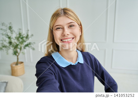 Smiling teen girl aged 16-17 taking a selfie Smiling teen girl aged 16-17 taking a selfie 141053252