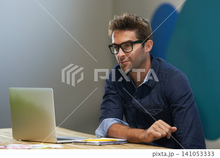Glasses, creative and man at laptop thinking for ideas, research and reading email in office. Brainstorming, computer and designer at desk with professional career, business plan and startup website 141053333