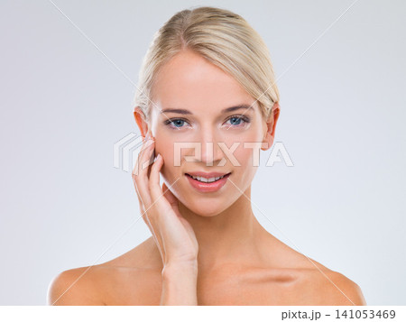 Woman, skincare and wellness in studio portrait with hand on face for results, touch and natural by white background. Girl, person and model with cosmetics, facial glow and transformation with smile 141053469