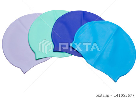 Four colorful silicone swimming caps arranged in an arc isolated on white background, set of bright waterproof swim hats Four colorful silicone swimming caps arranged in an arc isolated on white background, set of bright waterproof swim hats 141053677