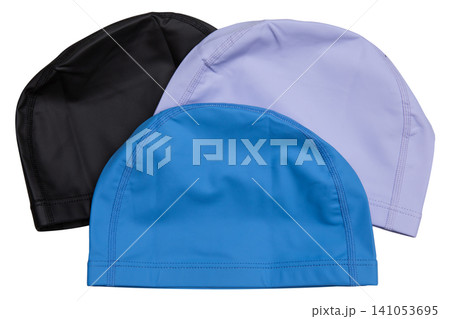 Three fabric swimming caps in black, lavender, and blue colors isolated on white background, trio of textile swim hats Three fabric swimming caps in black, lavender, and blue colors isolated on white background, trio of textile swim hats 141053695