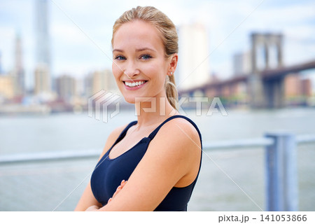 Exercise, portrait and woman with arms crossed for fitness, morning workout or running competition in city. Smile, wellness and face of female person for cardio, energy and confidence in New York 141053866