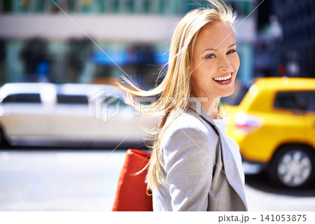 Woman, portrait and smile with city, walk and commute for work or career. Designer, job and new york street with urban, summer and happiness with confident and creative business travel in downtown 141053875