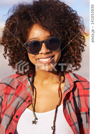 Fashion, portrait and black woman with sunglasses for trendy, edgy and hipster clothing in city of San Francisco. Smile, afro and face of female person for style, eyewear and confidence in park Fashion, portrait and black woman with sunglasses for trendy, edgy and hipster clothing in city of San Francisco. Smile, afro and face of female person for style, eyewear and confidence in park 141053930
