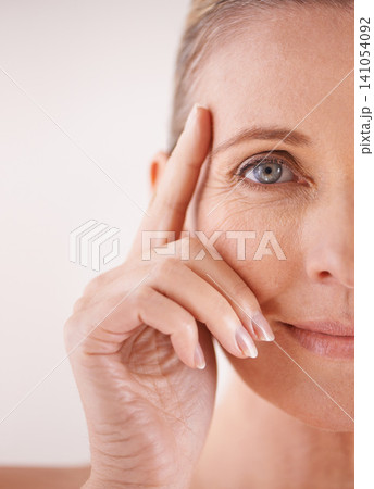 Mature, half or woman with skincare, portrait and cosmetics for facial treatment, confidence or wellness. Female model, studio and person with beauty glow for anti aging results on white background Mature, half or woman with skincare, portrait and cosmetics for facial treatment, confidence or wellness. Female model, studio and person with beauty glow for anti aging results on white background 141054092