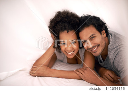 Couple, portrait and bed with sheet for relax morning or calm for partnership cozy, bonding or apartment. Man, woman and happy under linen or honeymoon love for vacation getaway, carefree or peaceful Couple, portrait and bed with sheet for relax morning or calm for partnership cozy, bonding or apartment. Man, woman and happy under linen or honeymoon love for vacation getaway, carefree or peaceful 141054136