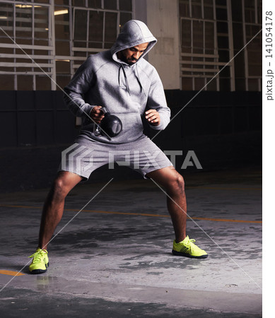 Man, kettlebell and muscle training for workout, strength exercise and healthy body in parking lot. Bodybuilder, equipment and challenge with weight for power, fitness and endurance development 141054178