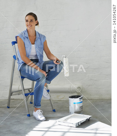Woman, ladder and roller brush for painting in home, remodeling and maintenance in apartment. Female person, smile and equipment for interior upgrade, diy and tool for house repairs or project Woman, ladder and roller brush for painting in home, remodeling and maintenance in apartment. Female person, smile and equipment for interior upgrade, diy and tool for house repairs or project 141054267