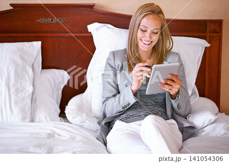 Bed, tablet and business woman online for website, social media and networking in hotel. Professional, remote work and person with pen on digital tech for contact, research and internet on work trip Bed, tablet and business woman online for website, social media and networking in hotel. Professional, remote work and person with pen on digital tech for contact, research and internet on work trip 141054306