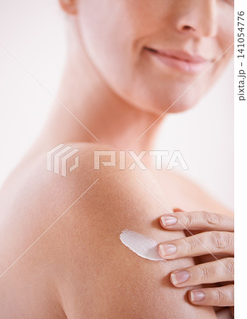 Woman, skincare and arm with cream for application, dermatology and cosmetics for wellness with smile. Female person, happy and body with product for self care, moisturizer or lotion for skin glow 141054776