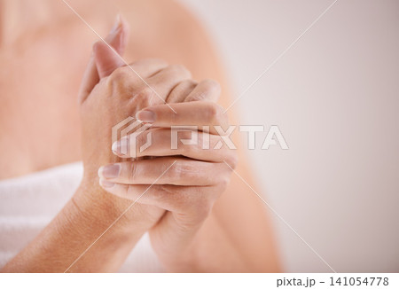 Woman, hands or lotion application for beauty, skincare or cosmetics for moisturiser or anti aging product. Fingers, closeup or person with smooth skin, creme or cream for glow or dermatology in home Woman, hands or lotion application for beauty, skincare or cosmetics for moisturiser or anti aging product. Fingers, closeup or person with smooth skin, creme or cream for glow or dermatology in home 141054778