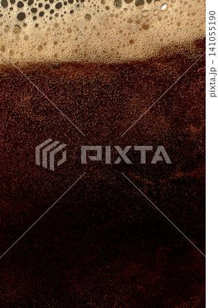 Dark beer foam texture with dense bubbles and rich stout layer. Dark beer foam texture with dense bubbles and rich stout layer. 141055190