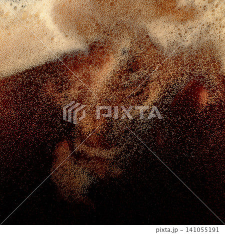Dark beer foam with swirling bubbles and creamy head texture. Dark beer foam with swirling bubbles and creamy head texture. 141055191