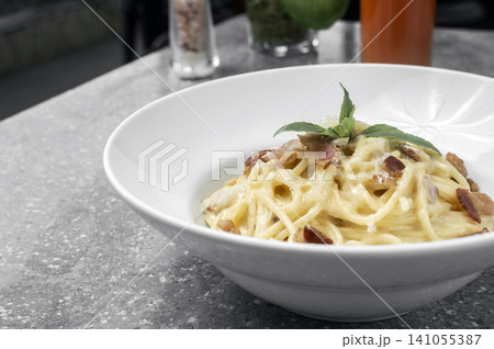 spaghetti carbonara creamy pasta with bacon and chesse on restaurant table spaghetti carbonara creamy pasta with bacon and chesse on restaurant table 141055387