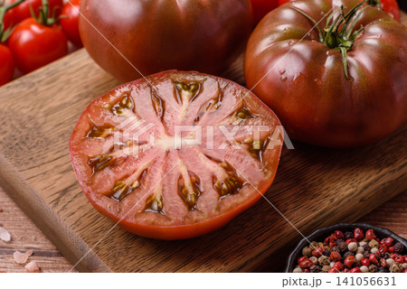 Fresh pink and black tomatoes adora or kumato as an ingredient for a salad. Tomatoes adora or kumato Fresh pink and black tomatoes adora or kumato as an ingredient for a salad. Tomatoes adora or kumato 141056631