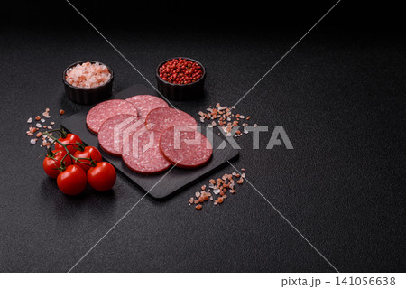 Slices of smoked salami or pepperoni for making sandwiches or pizza at home. Sausage slices Slices of smoked salami or pepperoni for making sandwiches or pizza at home. Sausage slices 141056638