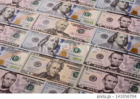 Paper US dollar bills of various denominations and cent coins as a business tool. Cash US dollars Paper US dollar bills of various denominations and cent coins as a business tool. Cash US dollars 141056704