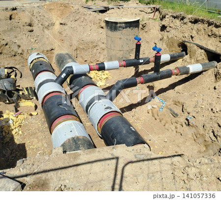 Underground Insulated District Heating Pipes in Construction Trench With Valves and Connections. Underground Insulated District Heating Pipes in Construction Trench With Valves and Connections. 141057336
