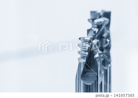 Macro photograph of a group of solid carbide end mill special cutting tools for CNC milling machine, isolated in a high-tech light blue scene. Macro photograph of a group of solid carbide end mill special cutting tools for CNC milling machine, isolated in a high-tech light blue scene. 141057385